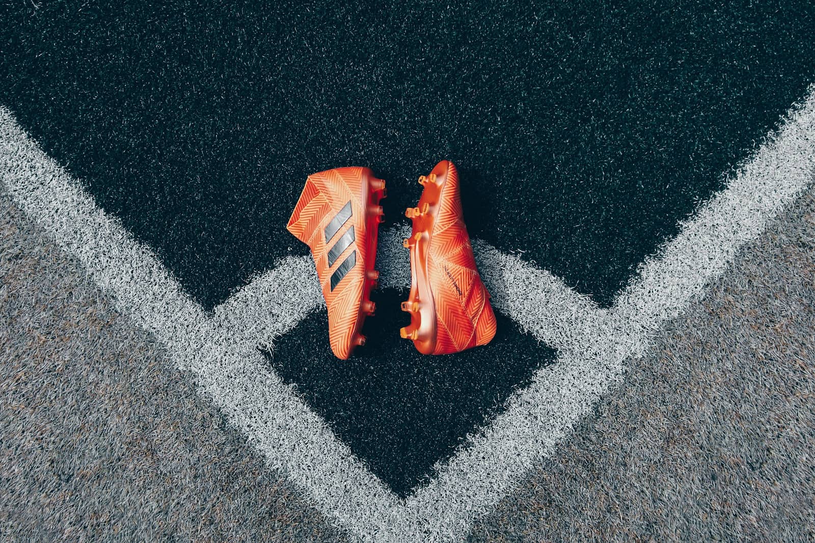 A pair of football boots on the corner of a pitch